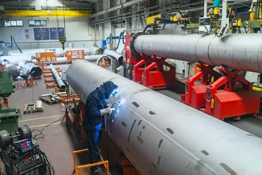 A welder working on large fabricated pipework
